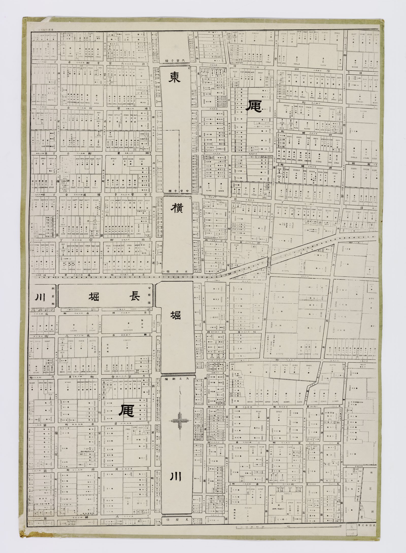 One sheet of a hundred and eleven, and there is nothing on it but property. Black line on cream, mounted on board: no colour, no relief, no landmark drawn as a picture. Every parcel is outlined to its surveyed shape with its lot number and its measured area printed inside it, in type small enough that the sheet has to be leaned over.<br><br>The canals are left blank white, their names set in large characters straight across the water; the ground on either side is packed edge to edge. A scale bar sits in the bottom corner. That is the whole of the decoration. The full atlas carries <b>1,002 town names</b>, most of them still on the street signs today.